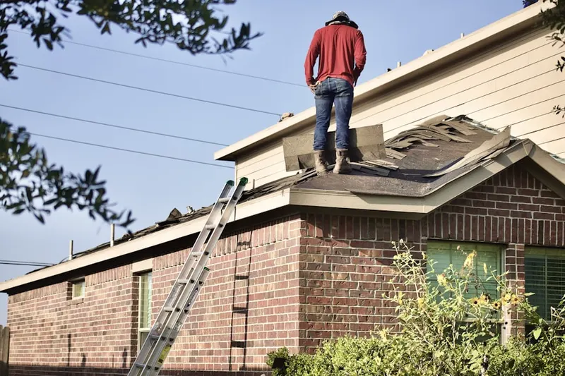 Professional roofer working on a residential roof in San Leon